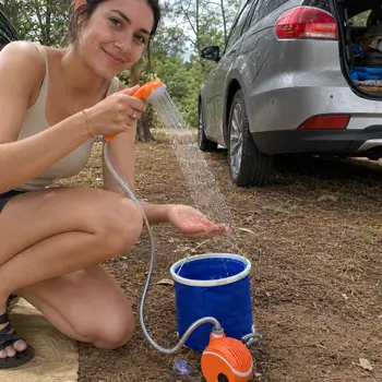 AquaTrail customer using the portable shower near a car
