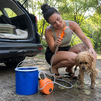 AquaTrail customer washing a dog beside a car